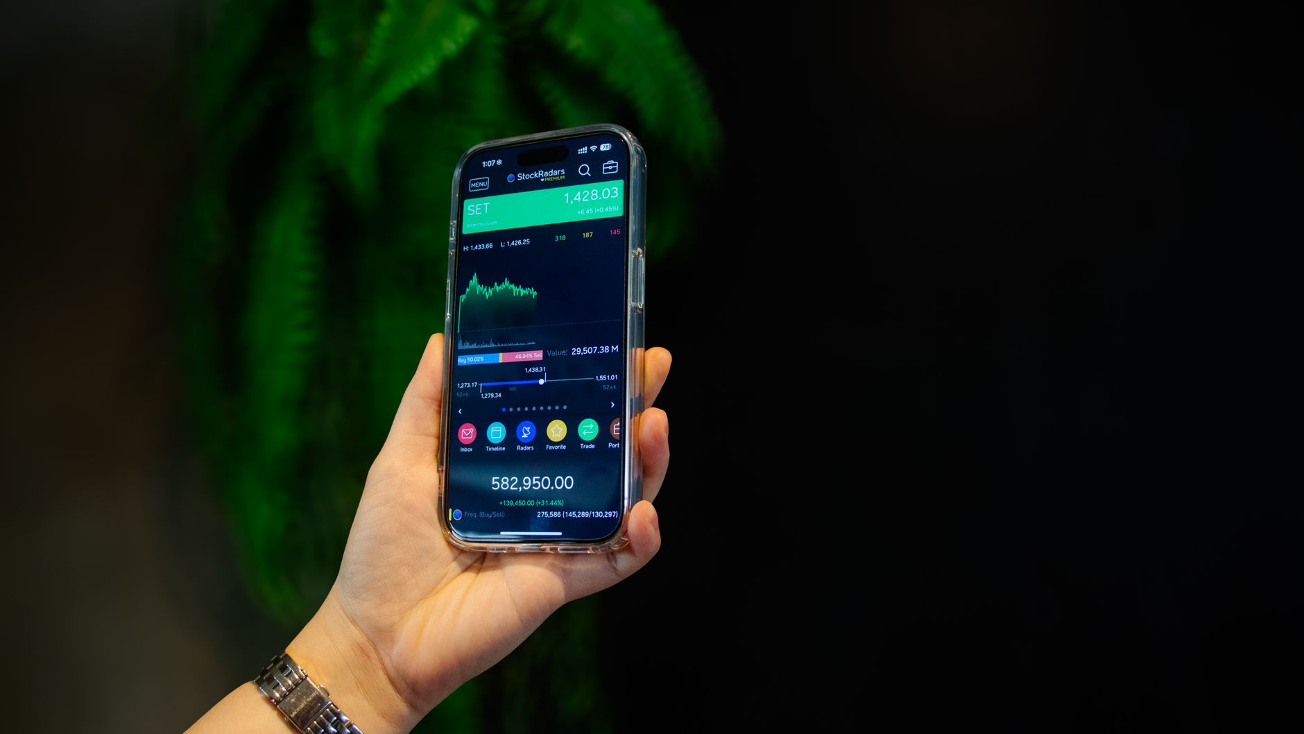 Ilustrasi: Close-up of a smartphone displaying a stock trading app with market data on-screen.