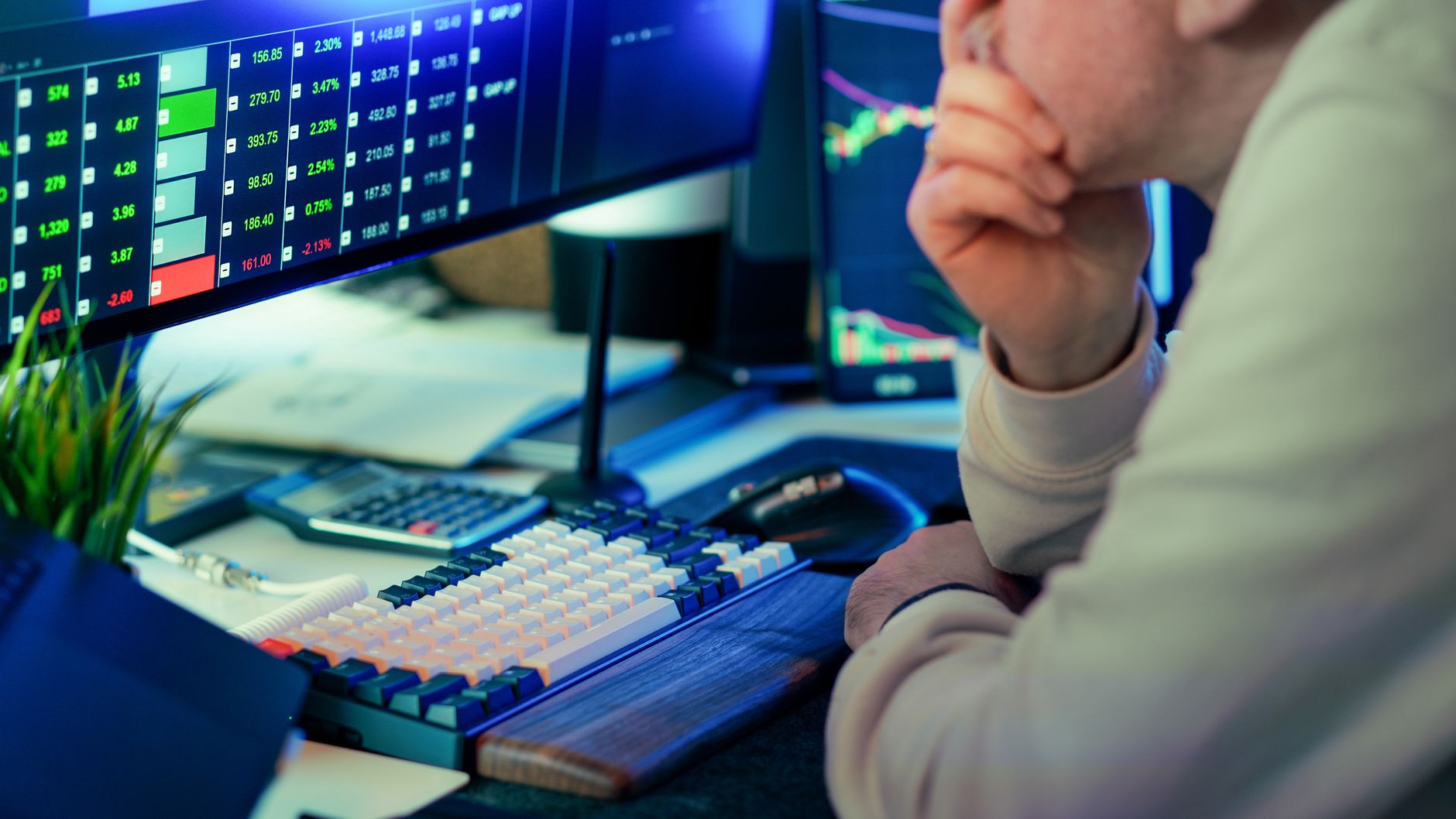 Ilustrasi: A stock trader intensely analyzing financial market data displayed on multiple screens in a modern office.