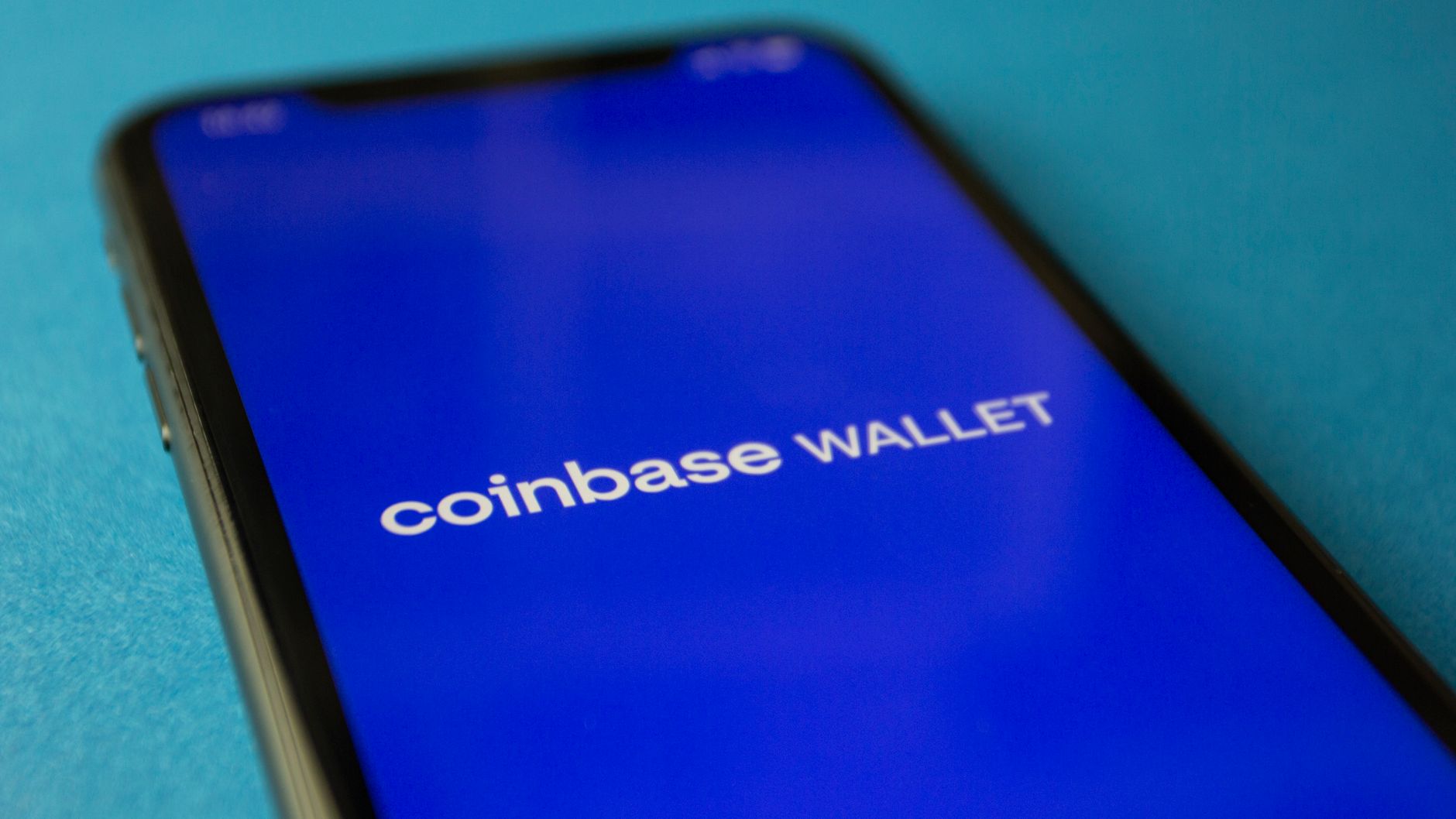 Ilustrasi: Close-up of a smartphone showing the Coinbase Wallet app interface for cryptocurrency transactions.