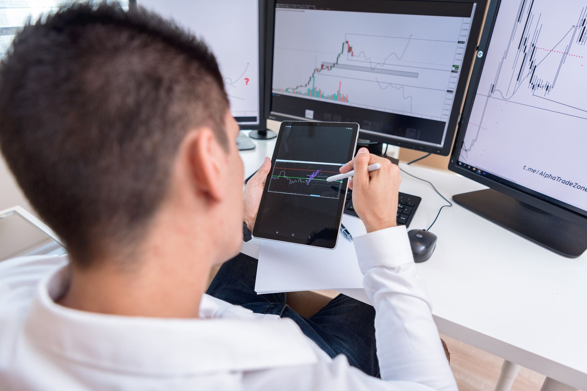 Ilustrasi: A trader reviewing cryptocurrency charts on a tablet in a modern office setting.
