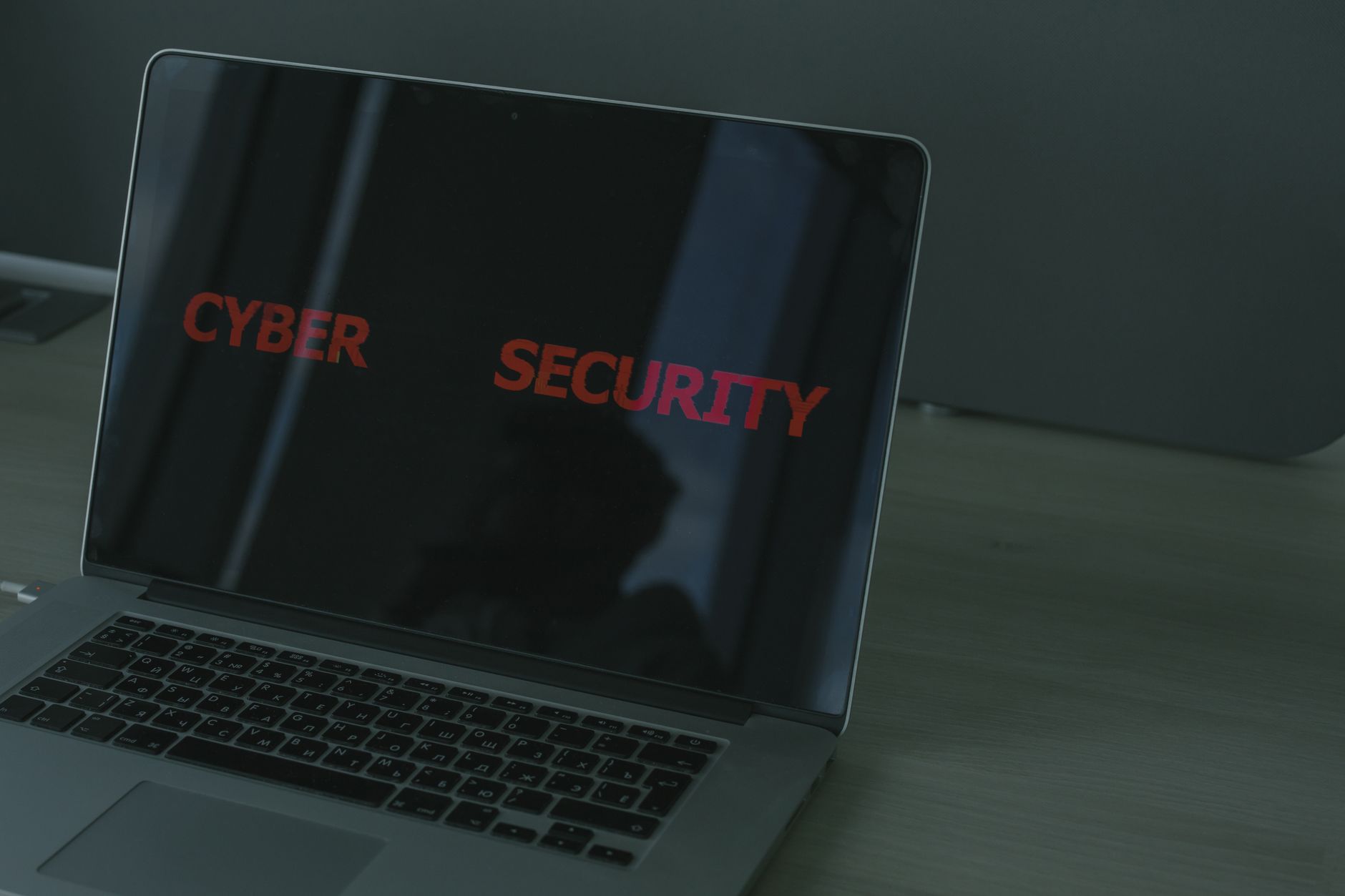Ilustrasi: Close-up of a laptop displaying cybersecurity text, emphasizing digital security themes.