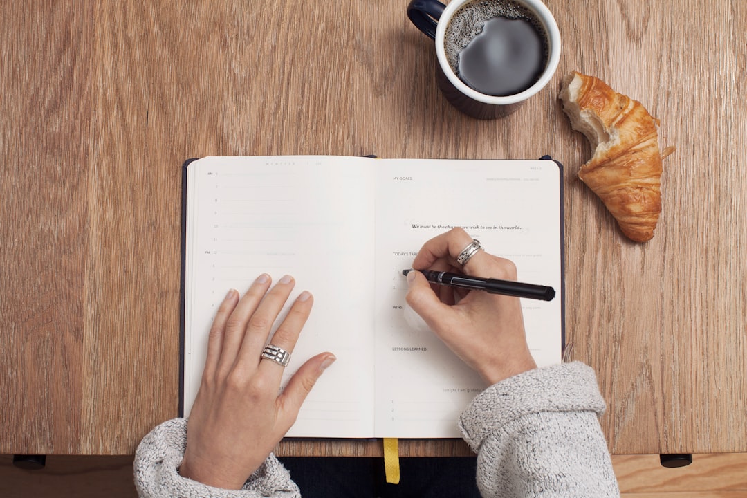 Ilustrasi: Person writing on a book